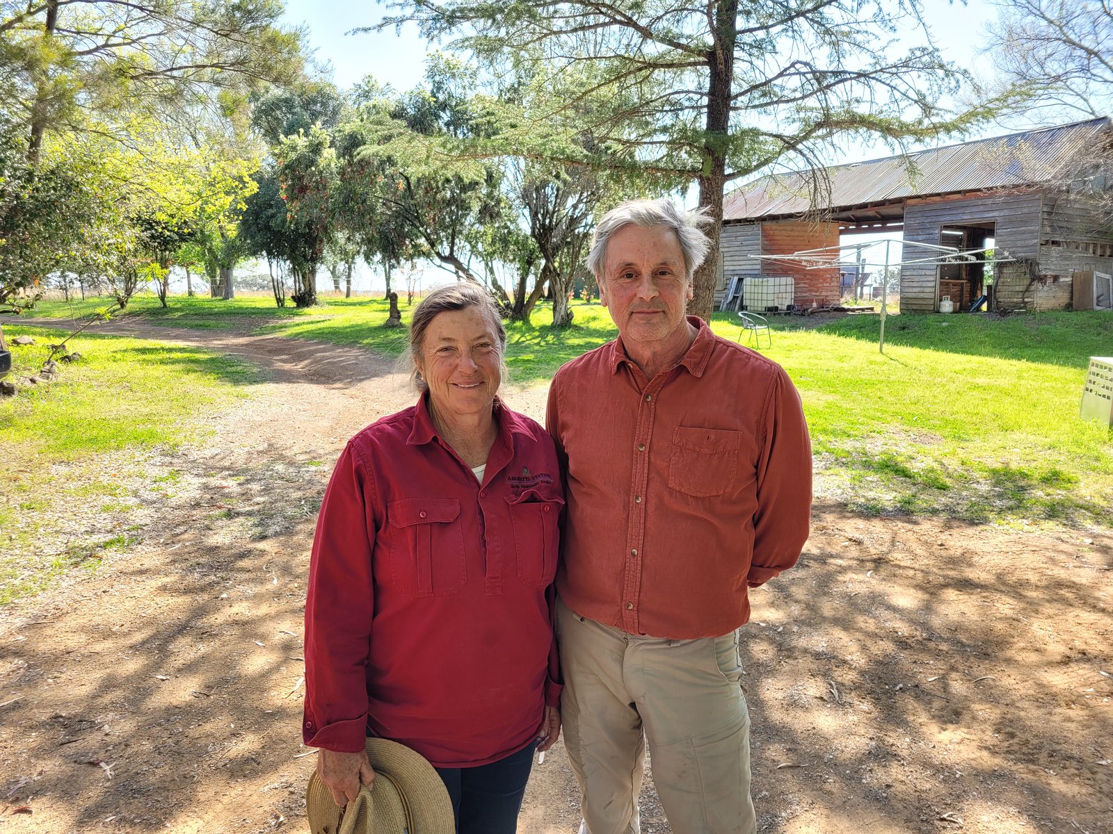 Susan Hendry and Grant Hilliard standing together outside buildings at Arrawatta Station.